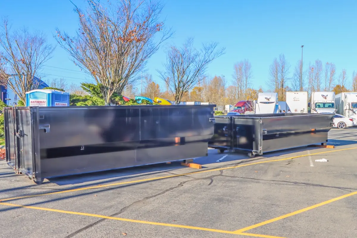 Professional dumpster rental service with roll-off container on residential driveway in Latimer